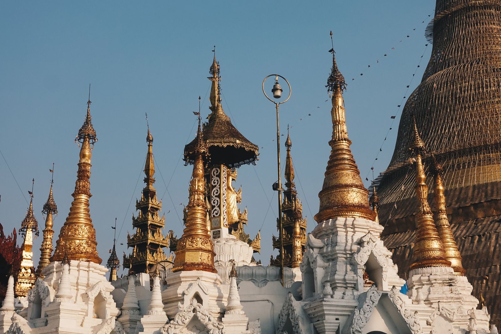 Golden spires of the Shwedagon Pagoda in Yangon against a blue sky, a must in any cruise Myanmar travel guide