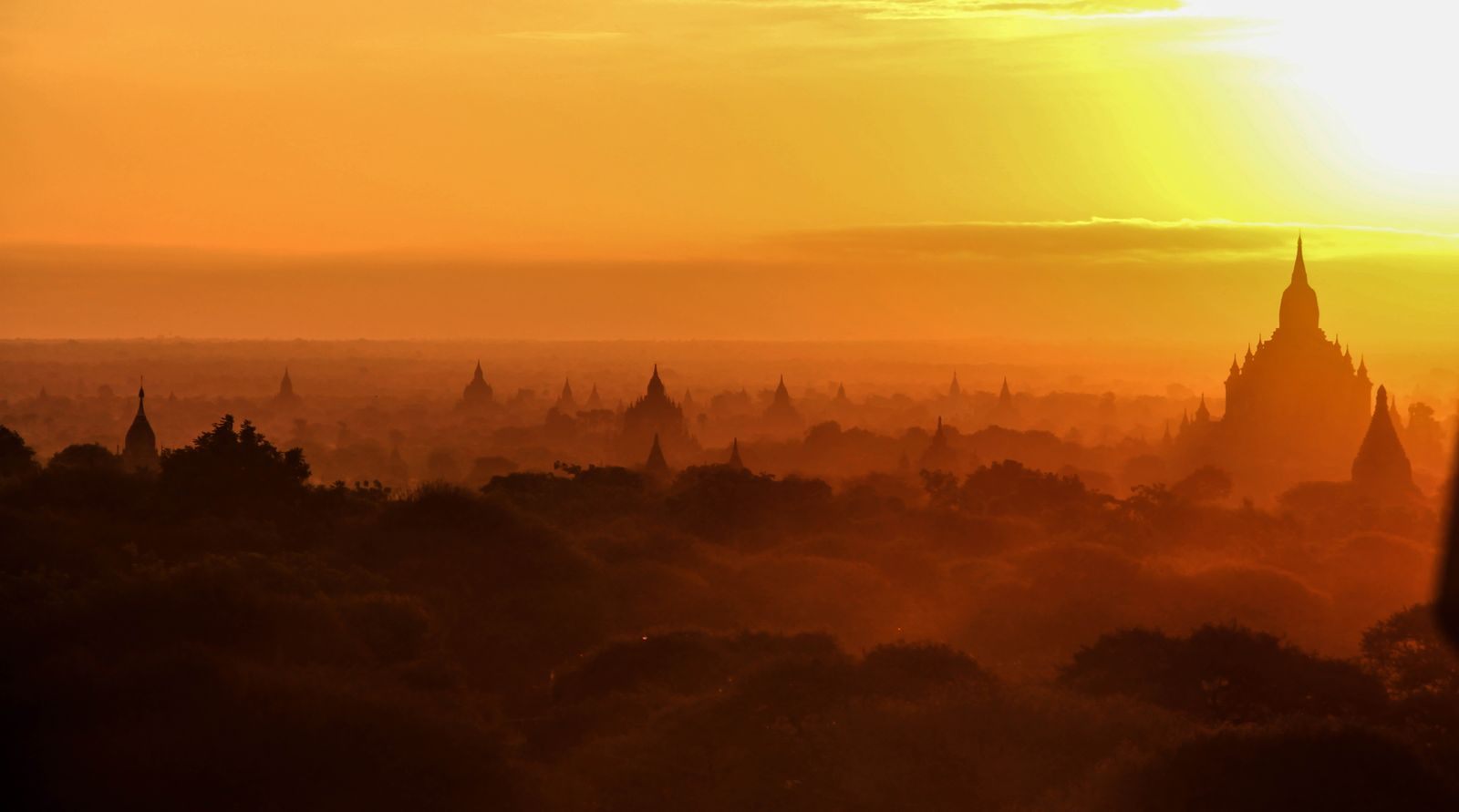 Golden sunrise over the temples of Old Bagan, the classic finale of a Myanmar river cruise