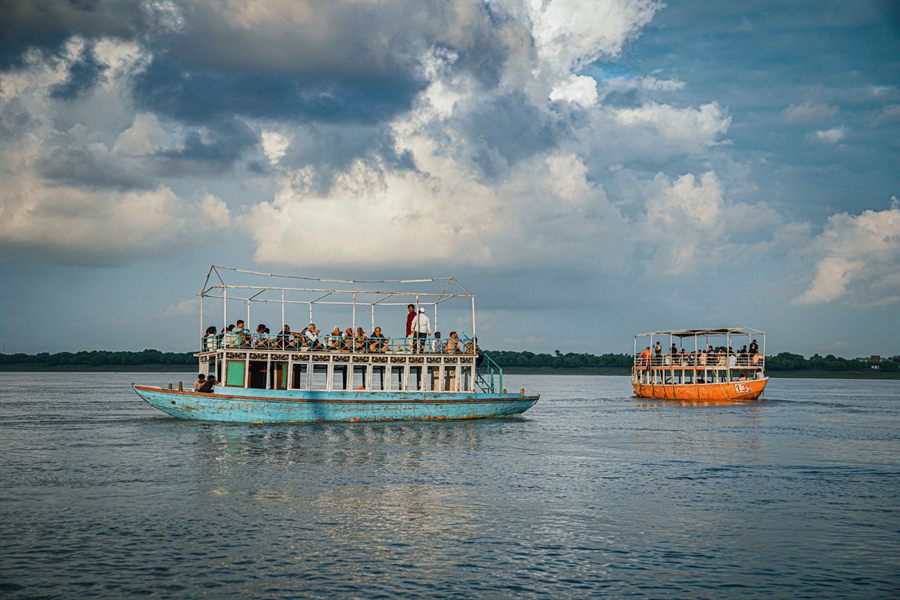 Tourist boats on the Ganges at Varanasi under dramatic clouds