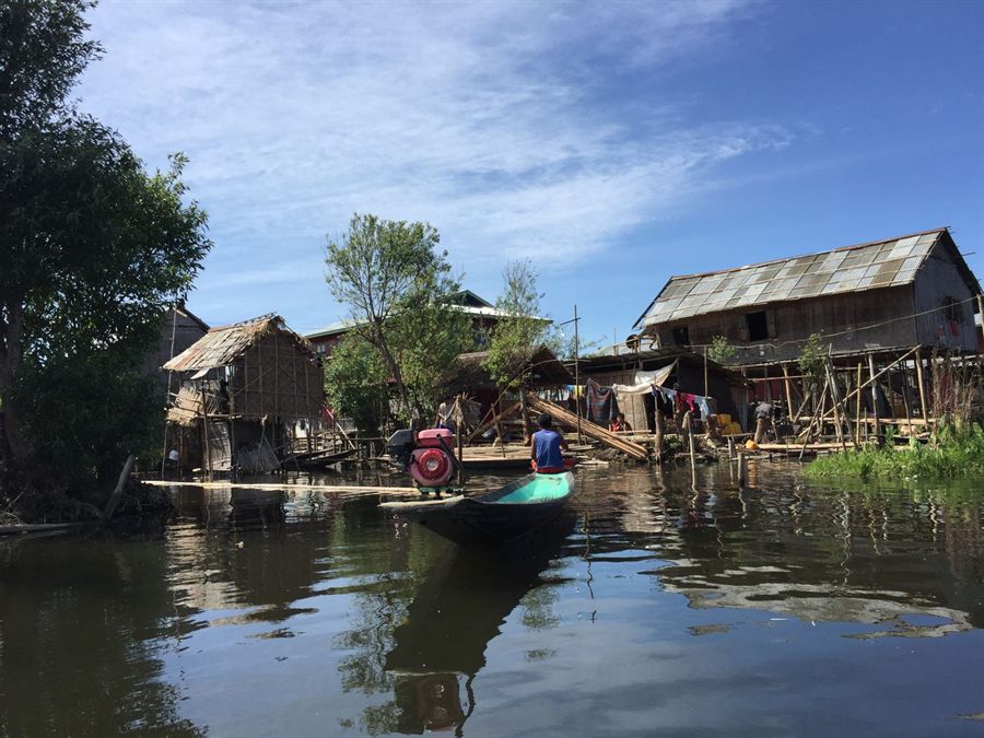Stilt houses and a small wooden boat in a village on Inle Lake, Myanmar